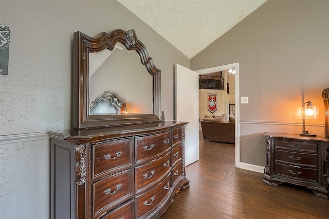 bedroom featuring vaulted ceiling, a textured ceiling, and dark hardwood / wood-style flooring