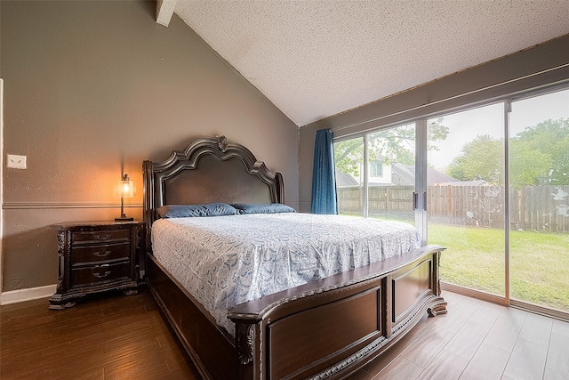 bedroom featuring a textured ceiling, lofted ceiling, hardwood / wood-style floors, and access to exterior