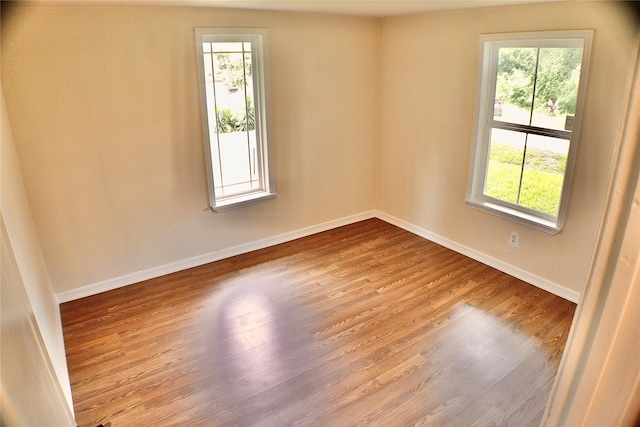 unfurnished room featuring hardwood / wood-style flooring