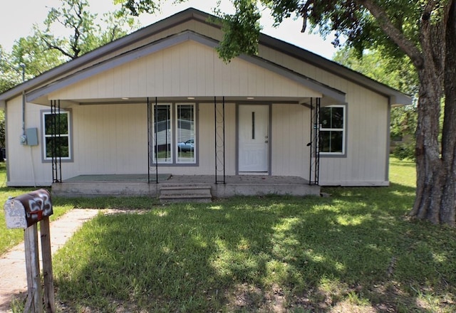 view of front of home with a porch and a front yard