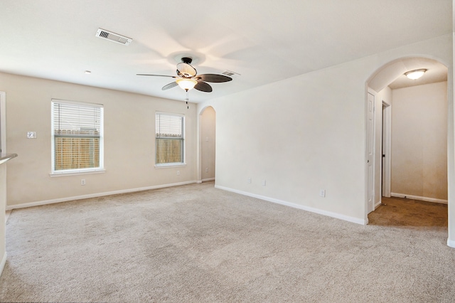 carpeted spare room with ceiling fan