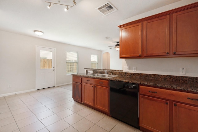 kitchen featuring arched walkways, a sink, visible vents, dishwasher, and dark stone countertops