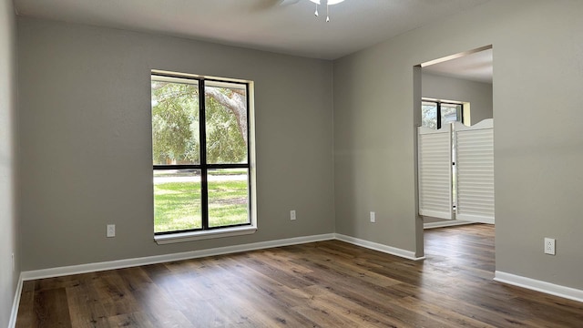 empty room featuring dark hardwood / wood-style flooring and ceiling fan