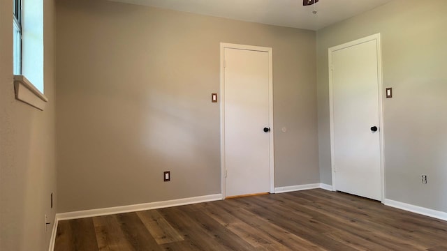 empty room with dark wood-type flooring