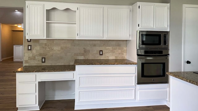 kitchen featuring dark stone counters, backsplash, dark hardwood / wood-style floors, and stainless steel appliances