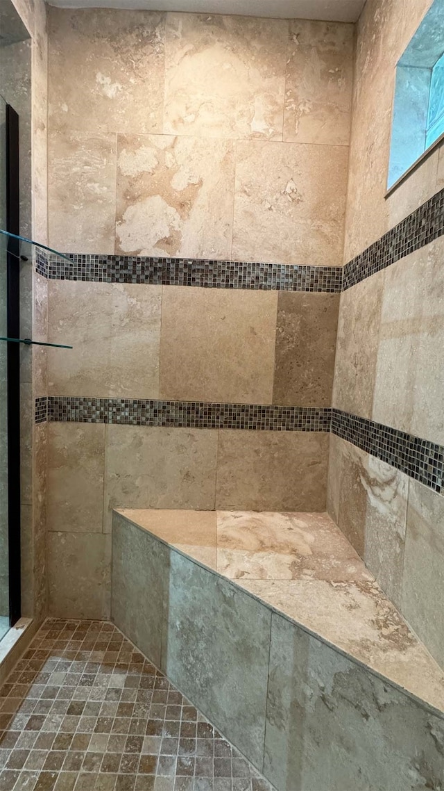 bathroom featuring tiled shower