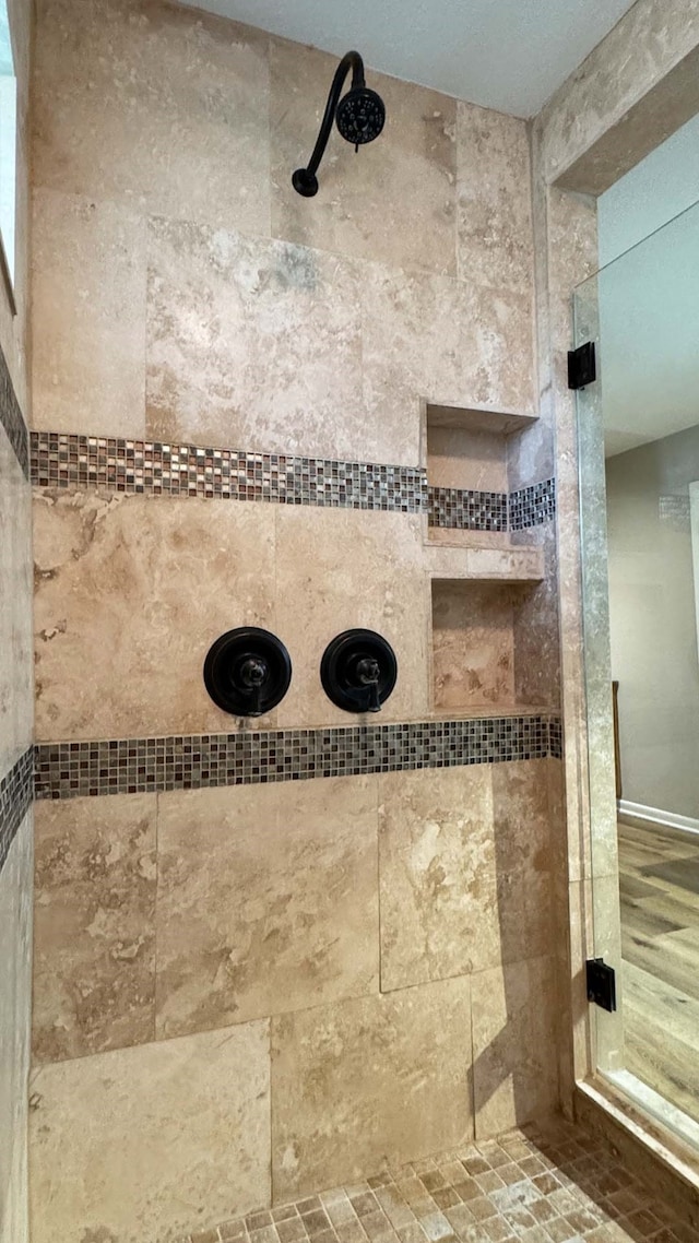 bathroom with a tile shower