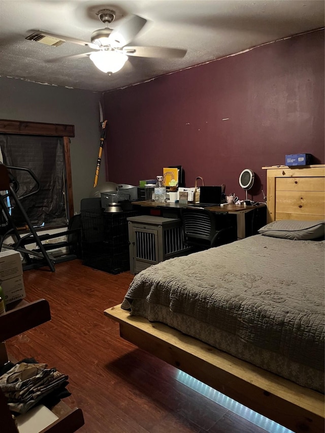 bedroom featuring ceiling fan and dark hardwood / wood-style floors