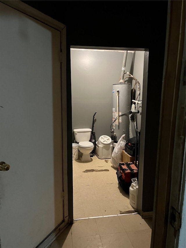 bathroom featuring toilet and gas water heater