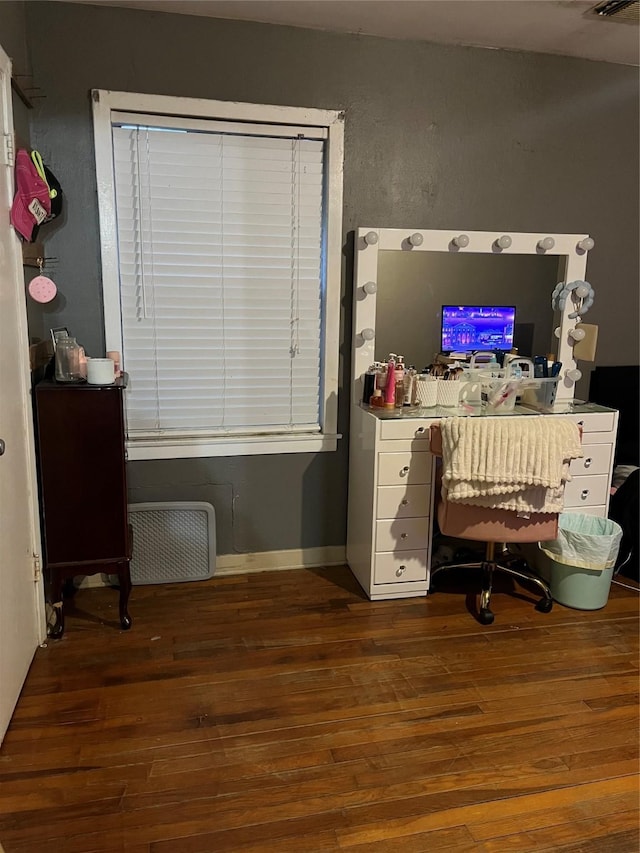 home office with dark hardwood / wood-style floors