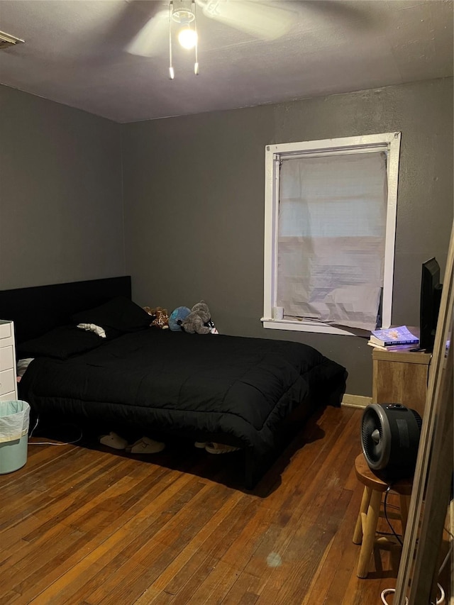 bedroom with ceiling fan and hardwood / wood-style floors