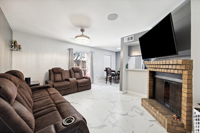 tiled living room featuring a brick fireplace