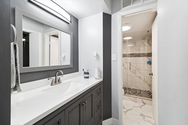 bathroom featuring tile patterned flooring, vanity, and tiled shower