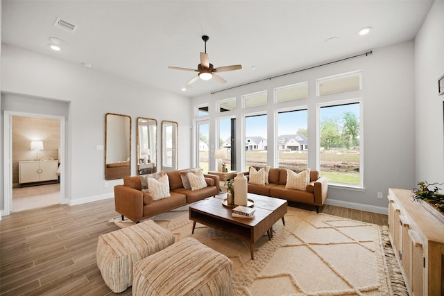 living area featuring recessed lighting, visible vents, baseboards, and light wood finished floors