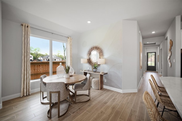 dining space featuring light wood finished floors, recessed lighting, and baseboards