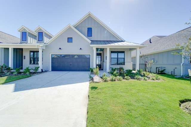 view of front of home with a front yard and a garage