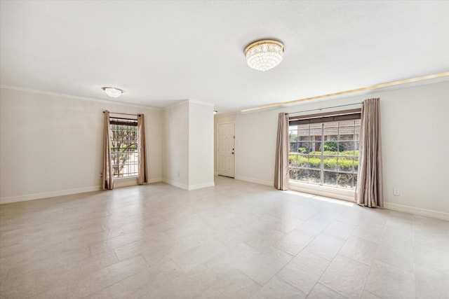 unfurnished room with crown molding