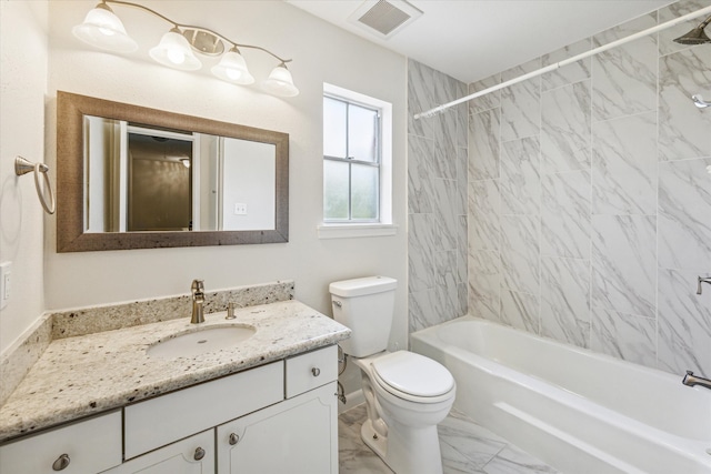 full bathroom featuring vanity, toilet, and tiled shower / bath