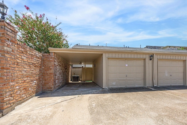 garage featuring central AC and a carport