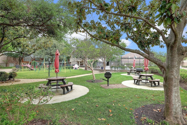 view of property's community featuring a playground and a yard