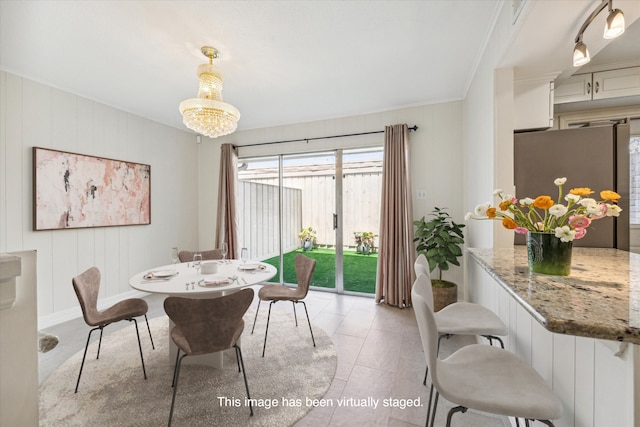 dining room featuring light tile patterned flooring, an inviting chandelier, and ornamental molding