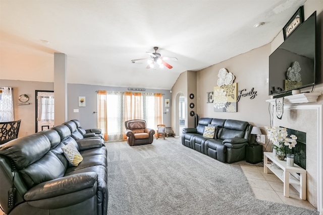 tiled living room featuring lofted ceiling and ceiling fan