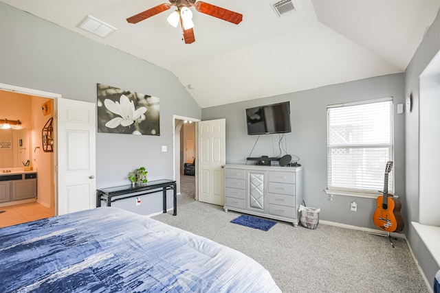 bedroom featuring ensuite bathroom, ceiling fan, lofted ceiling, and light colored carpet