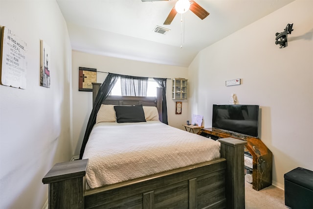 bedroom featuring vaulted ceiling, light carpet, and ceiling fan