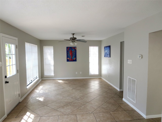 tiled empty room with ceiling fan