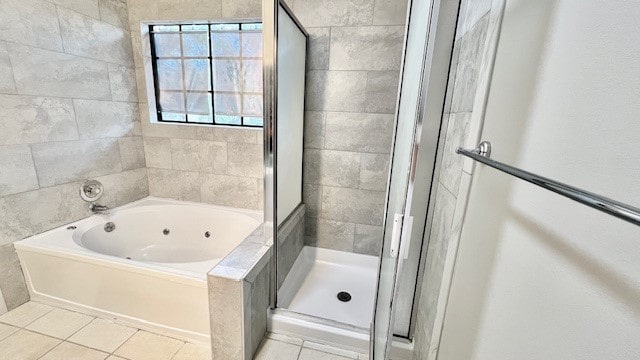 bathroom with tile patterned flooring and shower with separate bathtub