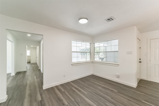 unfurnished room featuring dark hardwood / wood-style flooring