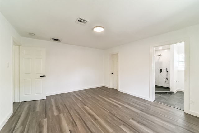 empty room with hardwood / wood-style flooring