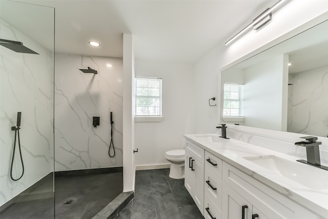 bathroom with dual vanity, toilet, plenty of natural light, and tile patterned floors