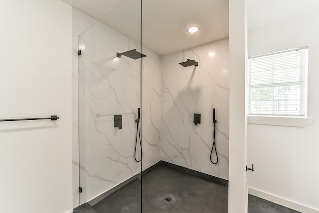 bathroom with tiled shower and concrete flooring