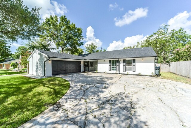 single story home with a front lawn and a garage