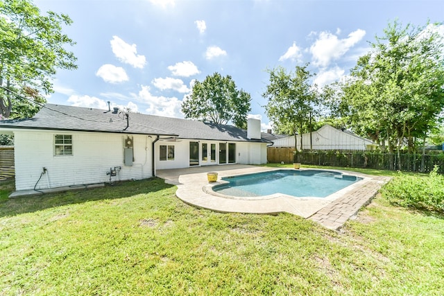 view of swimming pool with a lawn and a patio area