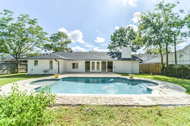 view of pool featuring a patio and a yard