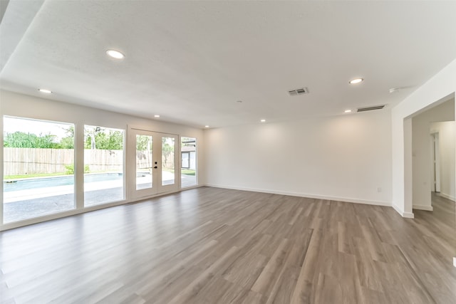 unfurnished room featuring hardwood / wood-style flooring and french doors