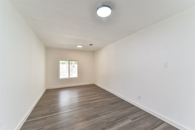 empty room featuring dark wood-type flooring