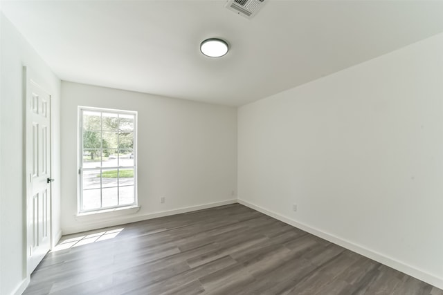 unfurnished room with hardwood / wood-style flooring