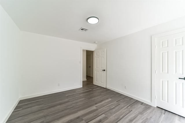 spare room featuring wood-type flooring