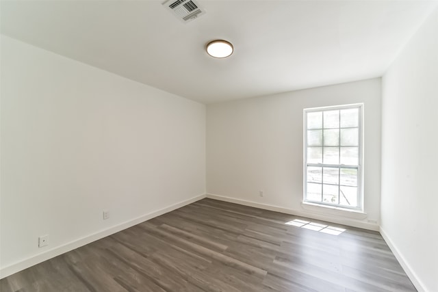 spare room featuring wood-type flooring