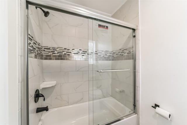 bathroom featuring bath / shower combo with glass door