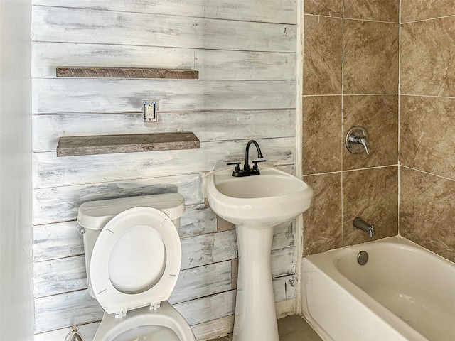 bathroom with wooden walls and toilet