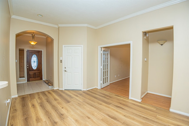 foyer with light wood-type flooring and ornamental molding