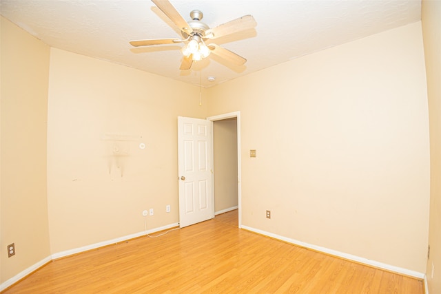 spare room featuring light hardwood / wood-style flooring and ceiling fan