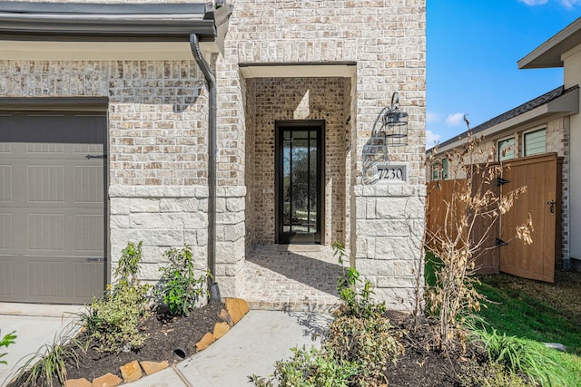 doorway to property with a garage