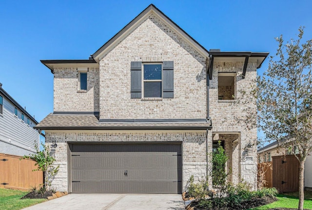 view of front of house featuring concrete driveway, brick siding, and fence