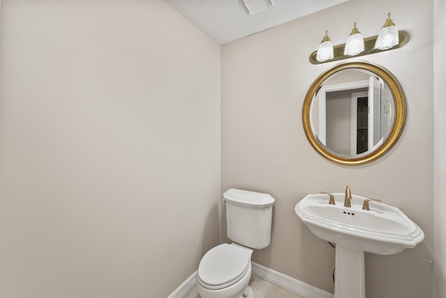 bathroom with sink, tile patterned flooring, and toilet