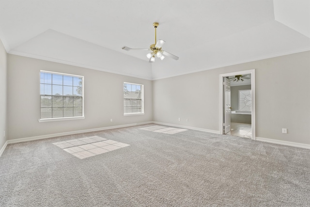 carpeted empty room with ceiling fan, a tray ceiling, and ornamental molding